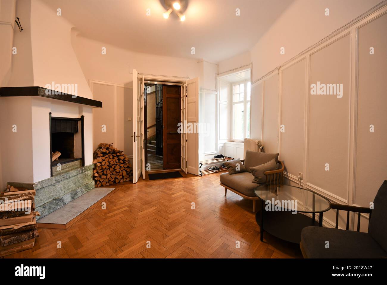 A cozy living room featuring a fireplace with cozy sofas Stock Photo
