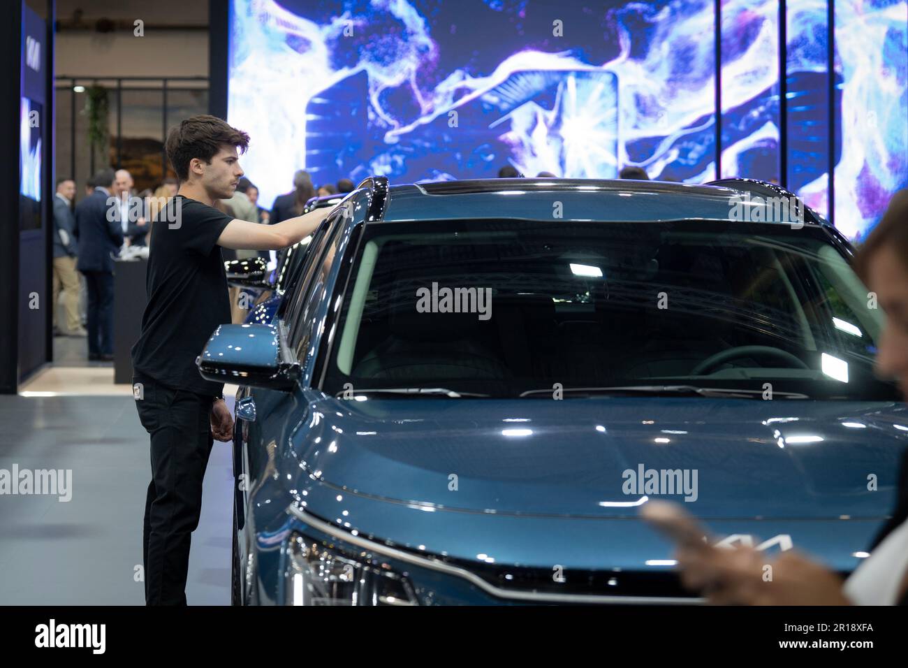 A young man stands in front of one of the new models of