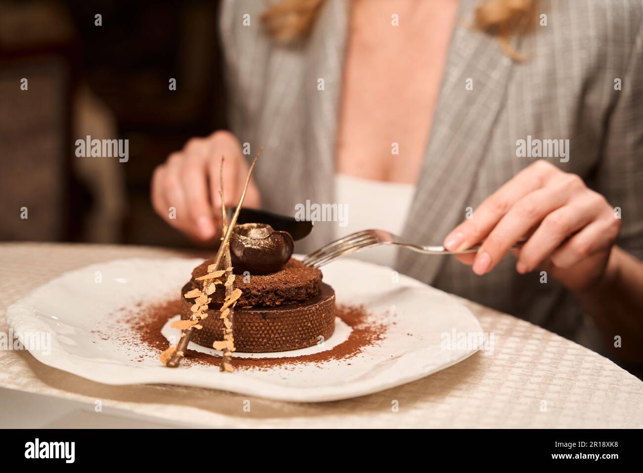 Woman trying sweet chocolate dessert at cafe Stock Photo - Alamy