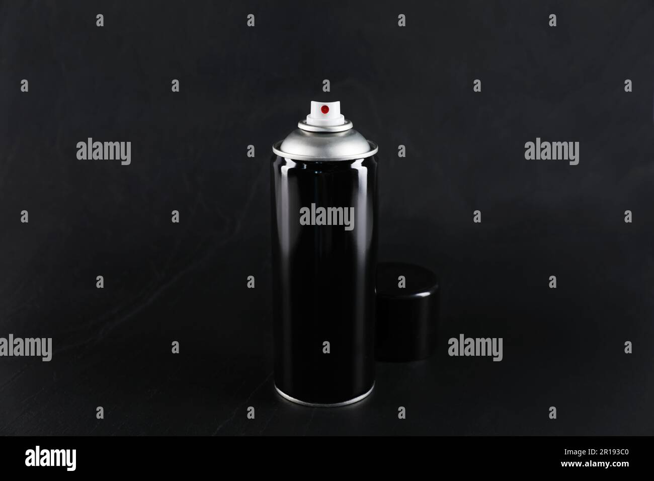Can of spray paint on black background Stock Photo - Alamy
