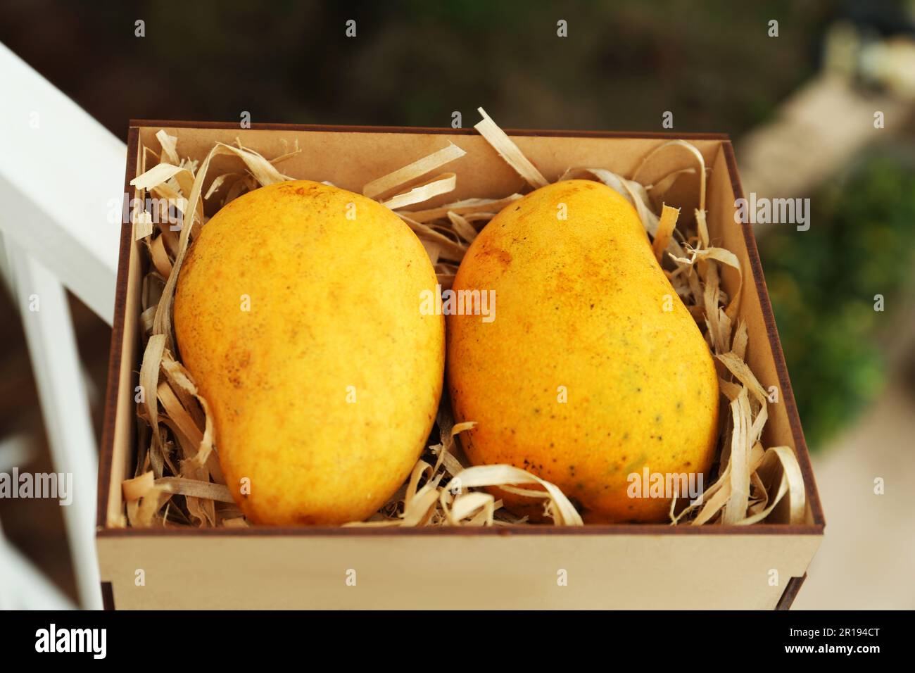 Delicious ripe yellow mangoes in wooden box outdoors Stock Photo - Alamy