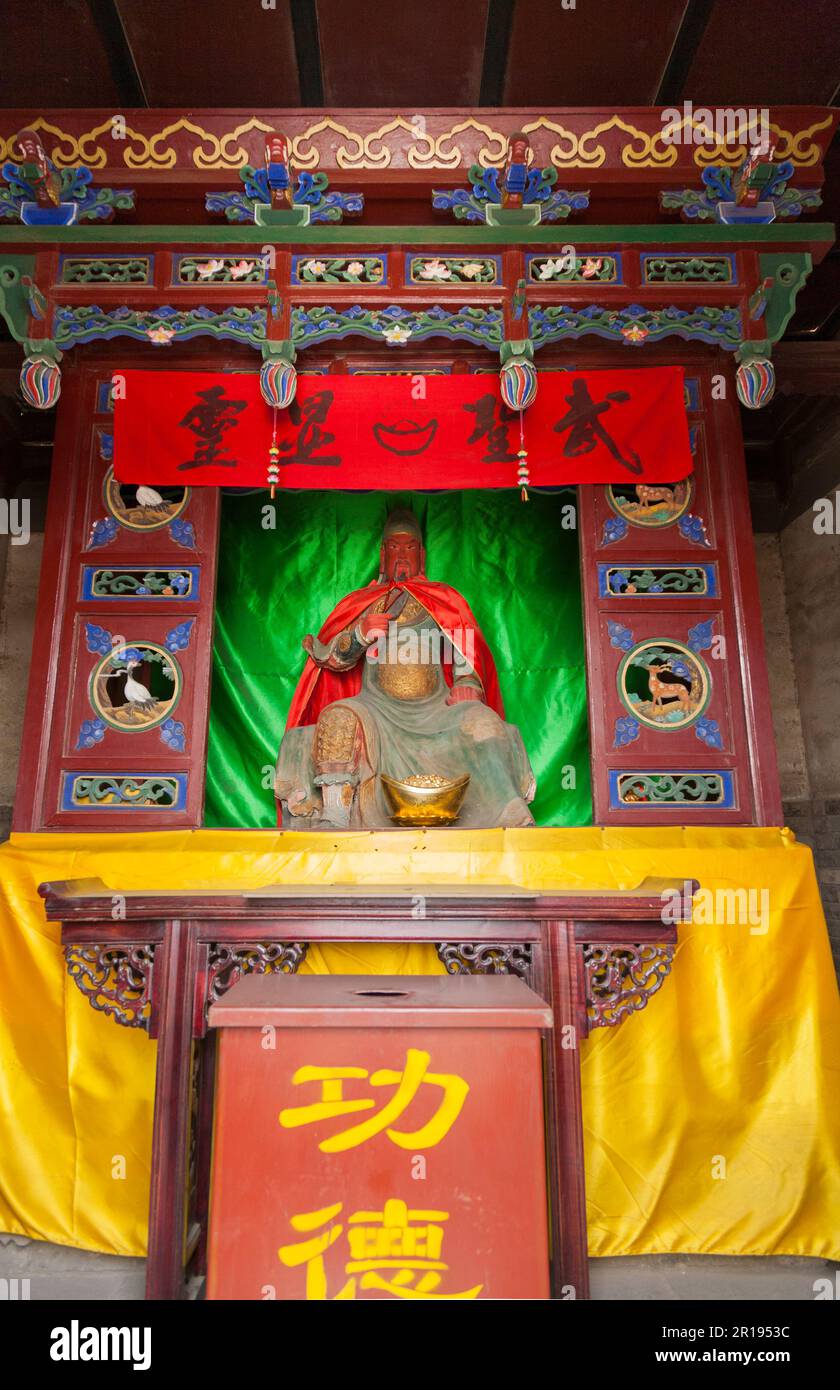 Religious shrine with deity or God like figure sculpture close to Feng Shui / Fengshi tower, Pingyao (Ancient) County Government Office Museum. PRC. China. (125) Stock Photo