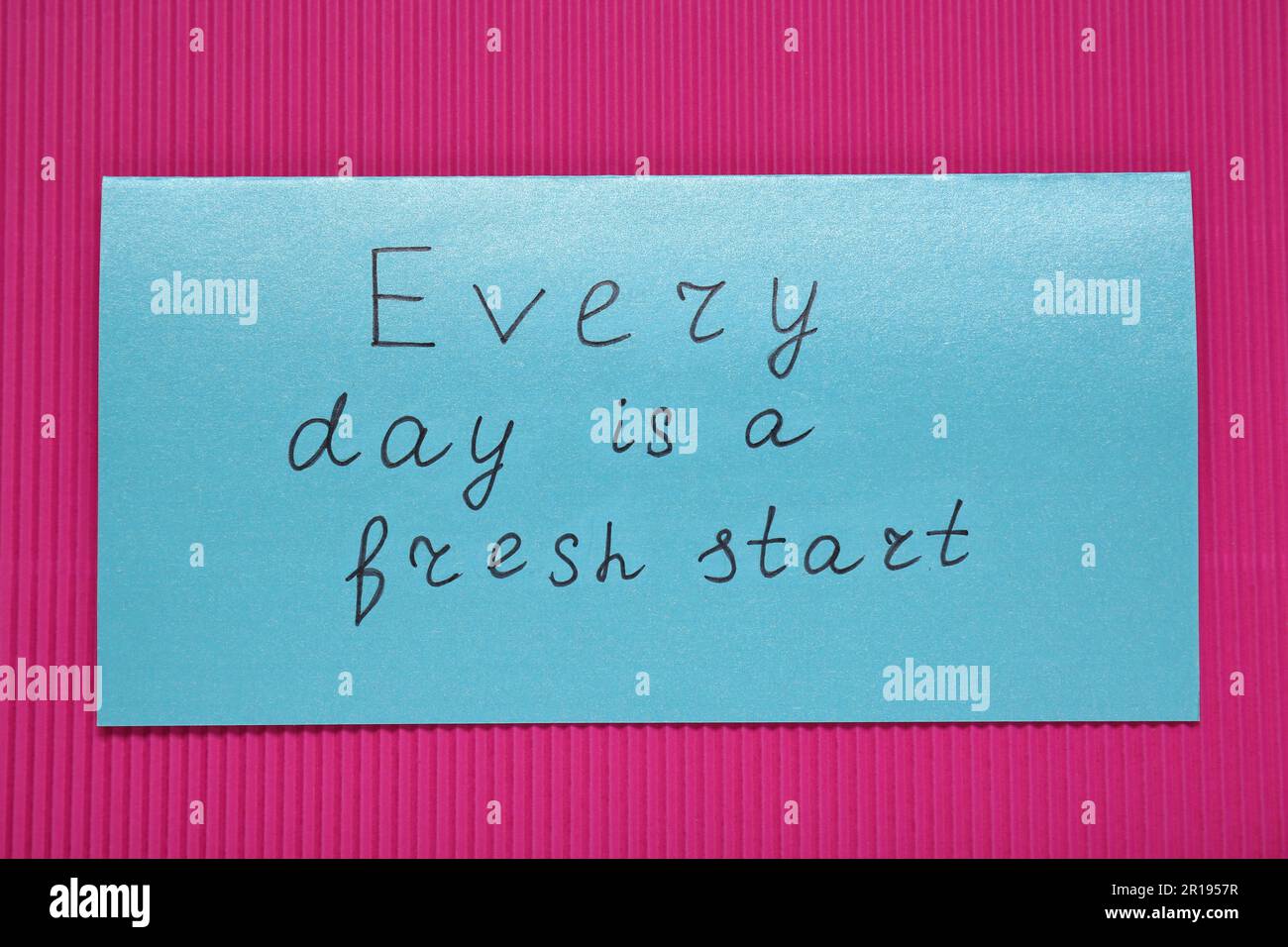 Card with phrase Every Day Is A Fresh Start on pink background, top view. Motivational quote Stock Photo