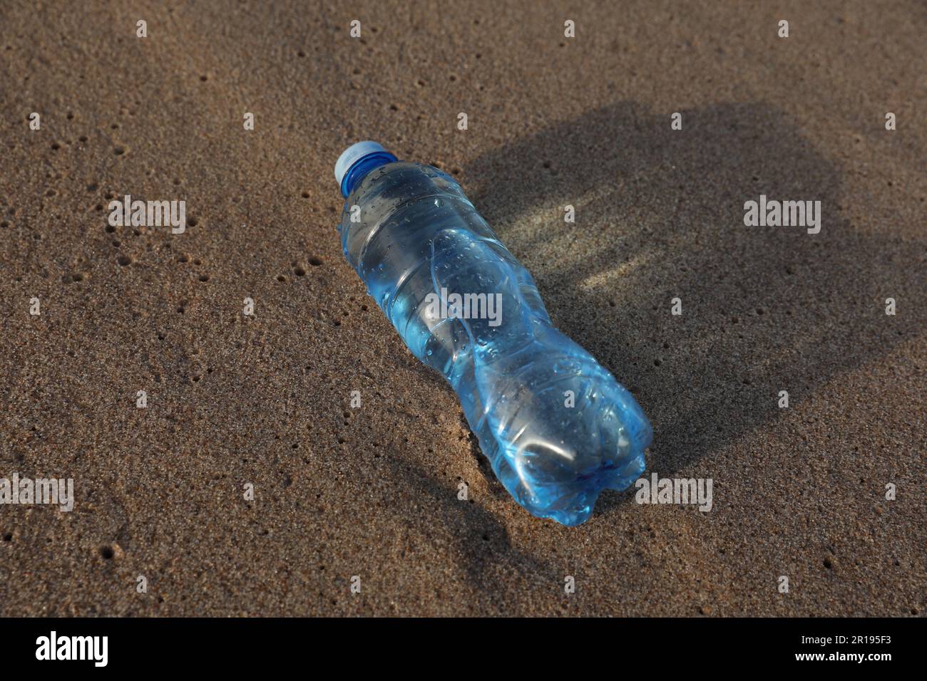 Plastic bottle of fresh water on wet sand Stock Photo Alamy