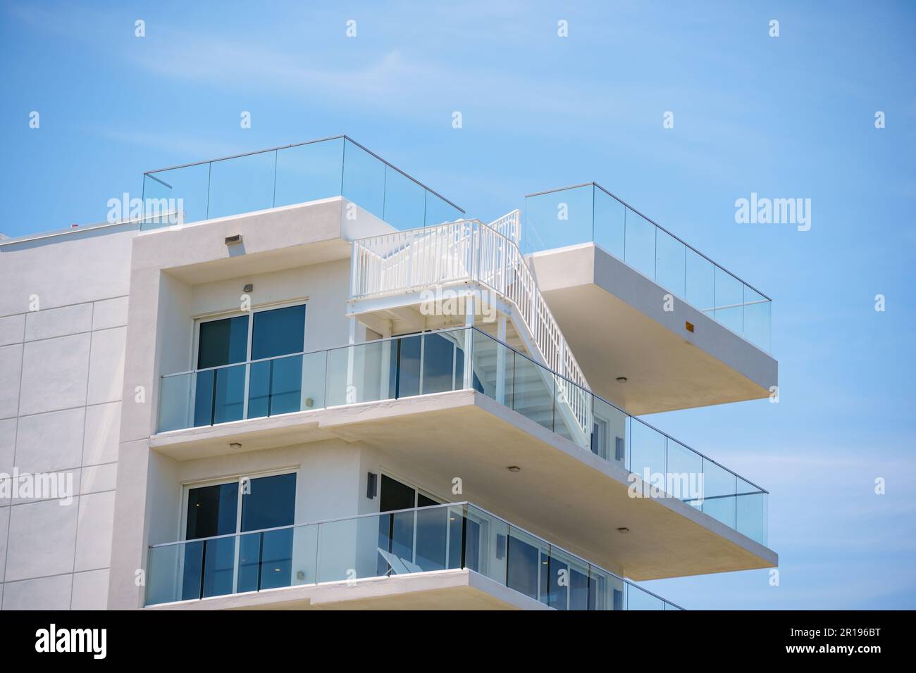 Closeup of a building with balcony and stairway to rooftop Stock Photo