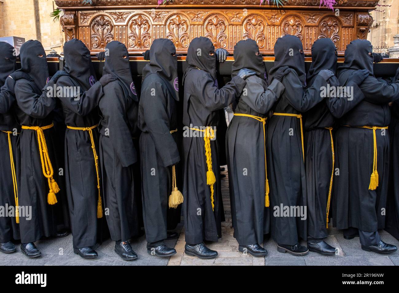 Members of the Brotherhood of Jesus in the Sacrament and Holy Mary of Mercy, Amparo de los Leoneses carry a Paso during Semana Santa, Leon, Spain Stock Photo