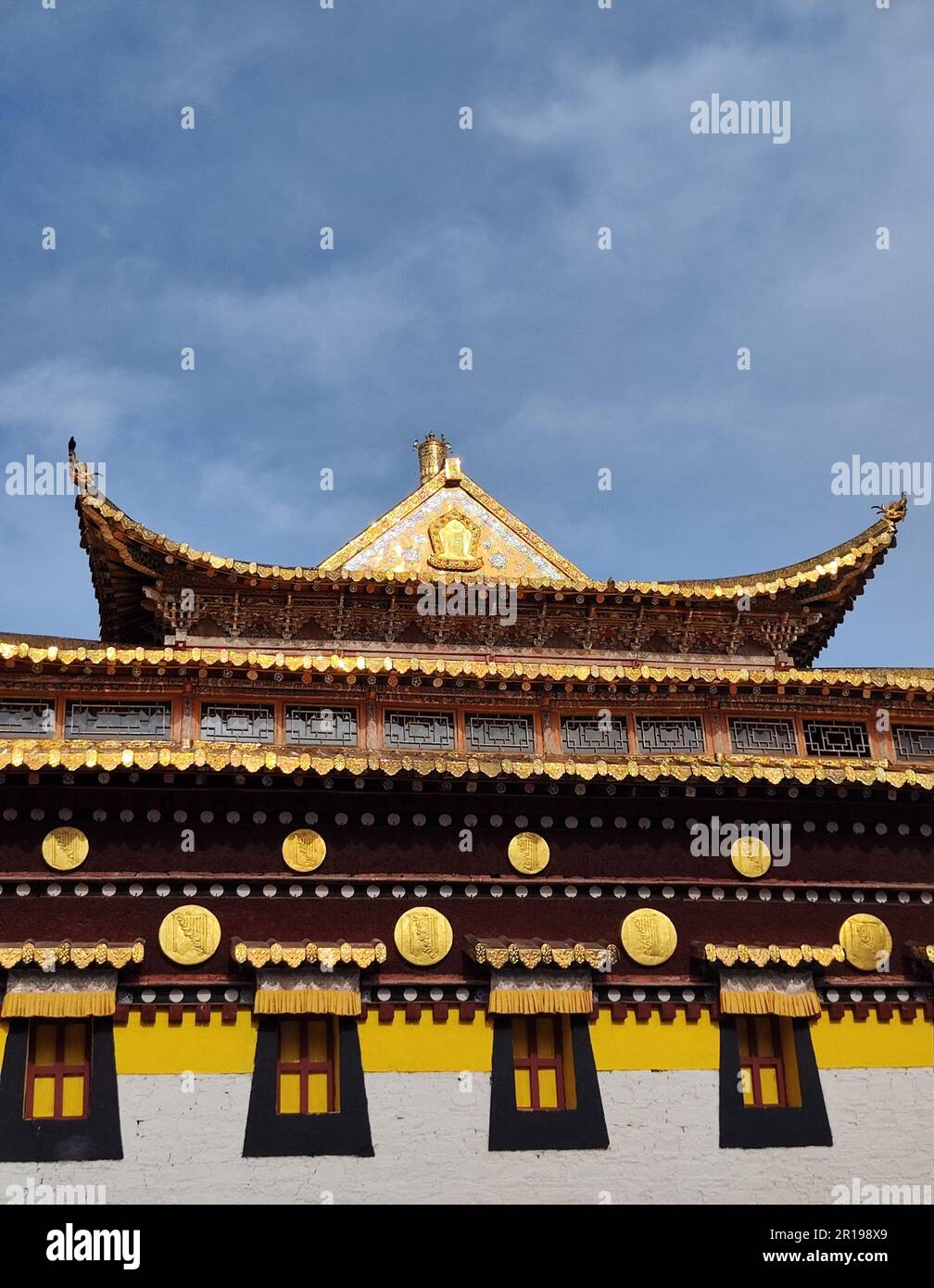 An architectural structure with a golden designs against a blue sky Stock Photo