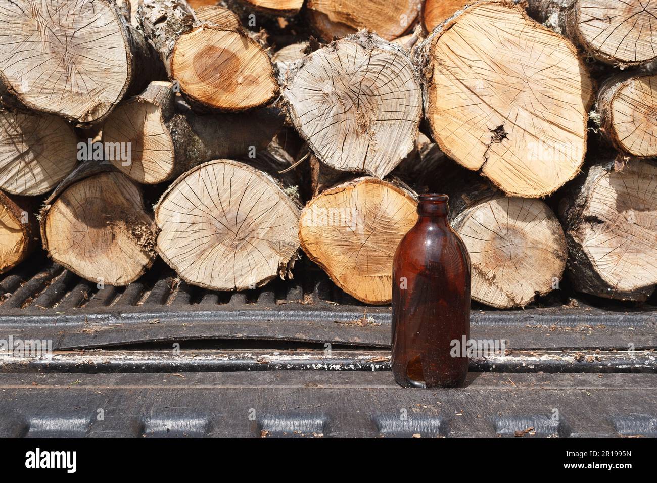 Stubby beer bottle and firewood on a pickup truck bed and tailgate Stock Photo Alamy