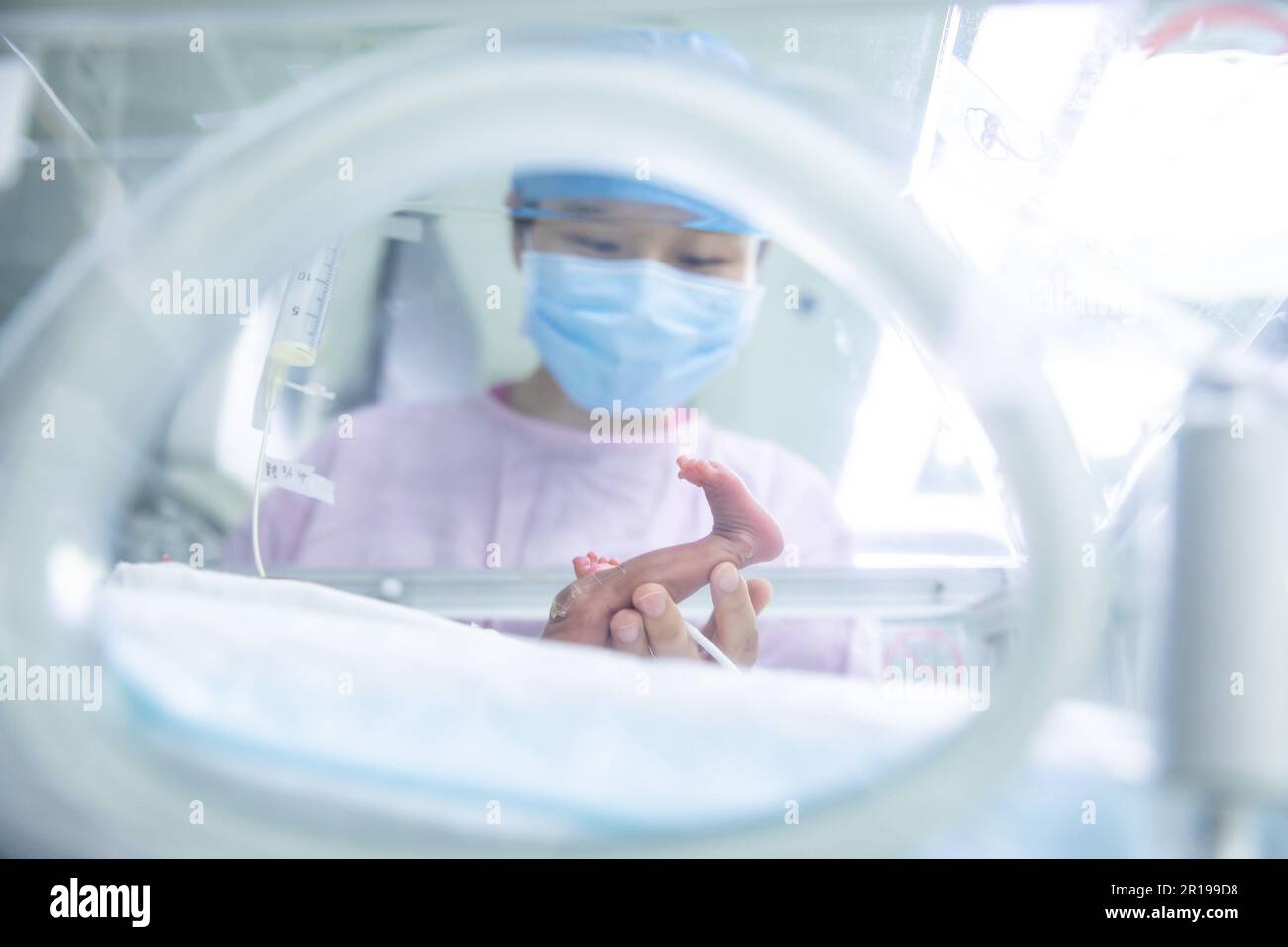 (230512) -- BEIJING, May 12, 2023 (Xinhua) -- Yang Chujia, a nurse of Neonatal Intensive Care Unit (NICU) checks the situation of a premature baby at around 11 o'clock p.m. at Peking Union Medical College Hospital (PUMCH) in Beijing, capital of China, May 9, 2023. Friday marks International Nurses Day. The number of nurses in China has experienced consistent growth over the past ten years, with an average yearly increase of 8 percent, according to the National Health Commission (NHC). The total number of registered nurses in China had exceeded 5.2 million at the end of last year, with rough Stock Photo