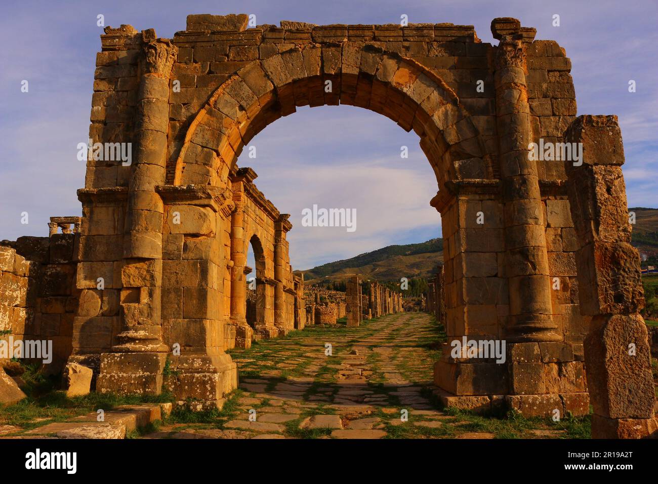 Djemila roman ruins, Algeria. Cardo maximus arc in the evening. Stock Photo