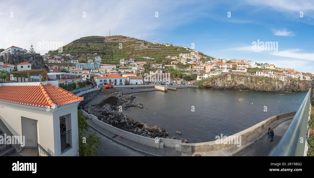 Madeira Island Portugal - 04 21 2023: Panoramic view Câmara do Lobos bay and harbour, a small touristic fisherman's village, main avenue facing the se Stock Photo