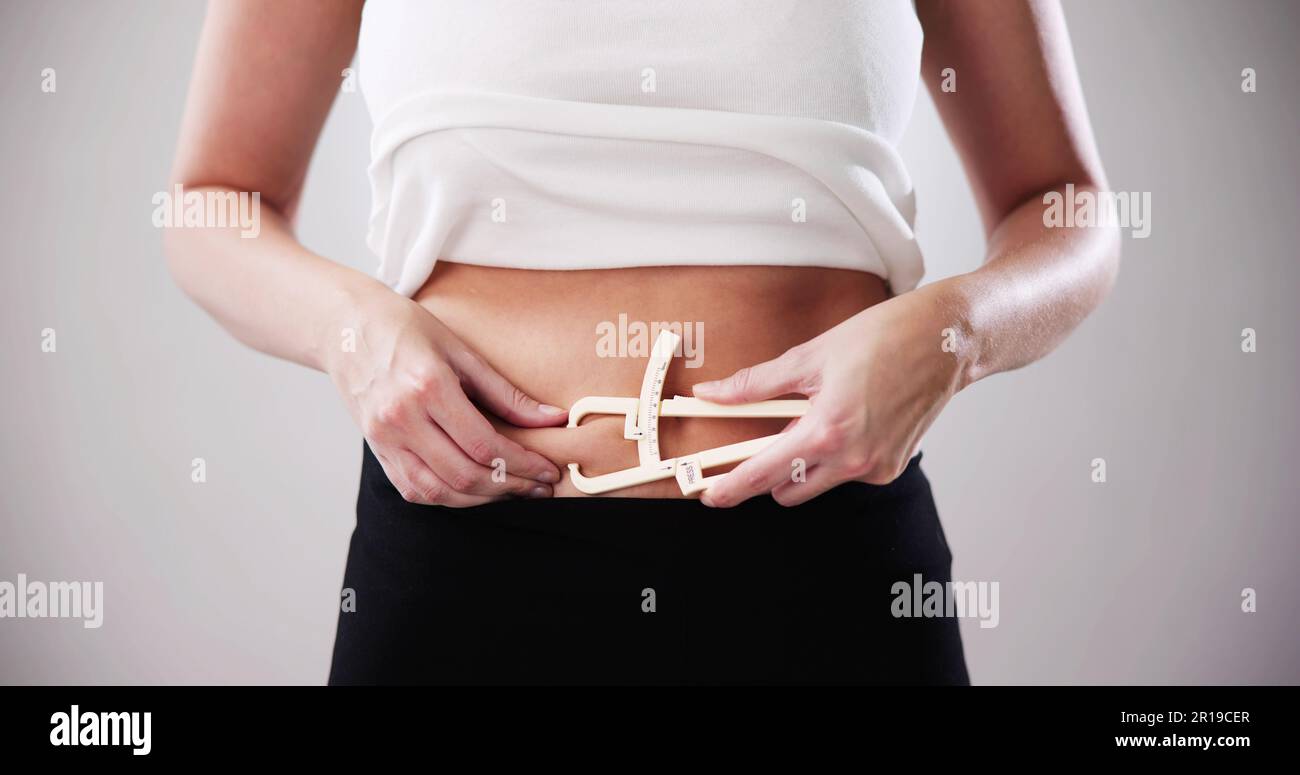 Female Hands Measuring Fat Belly With Fat Caliper Stock Photo Alamy