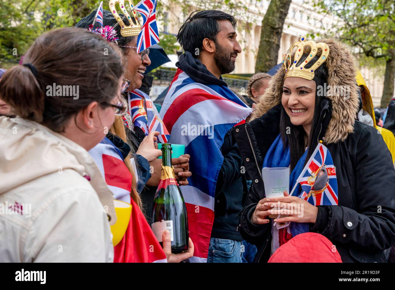 Young British People Standing On The Mall Toast The New King, The Coronation of King Charles III, London, UK. Stock Photo