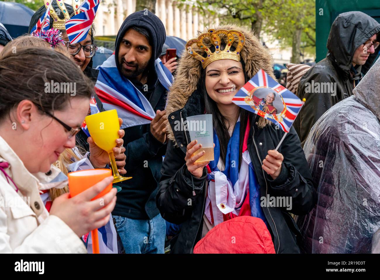Young British People Standing On The Mall Toast The New King, The Coronation of King Charles III, London, UK. Stock Photo