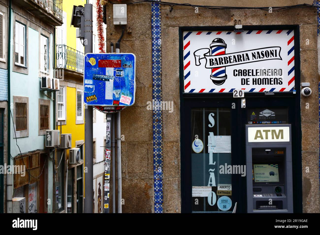 Euronet Worldwide ATM cash machine, cul-de-sac sign and barbers shop in Old Town, Porto / Oporto, Portugal Stock Photo