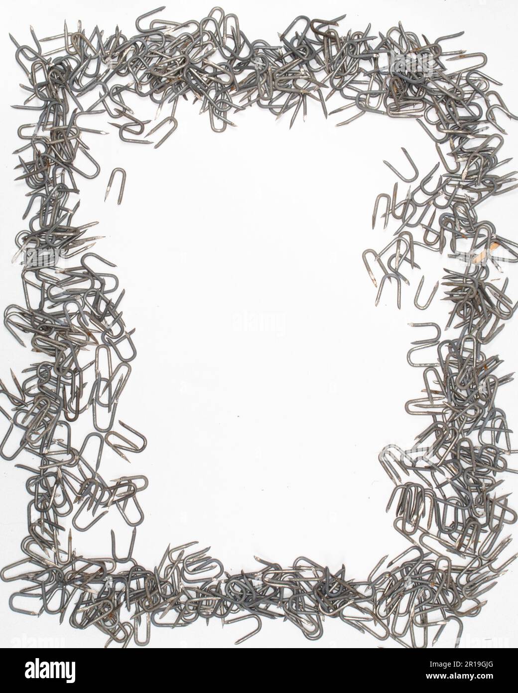 vertical frame of heavy barbed wire staples materials for construction