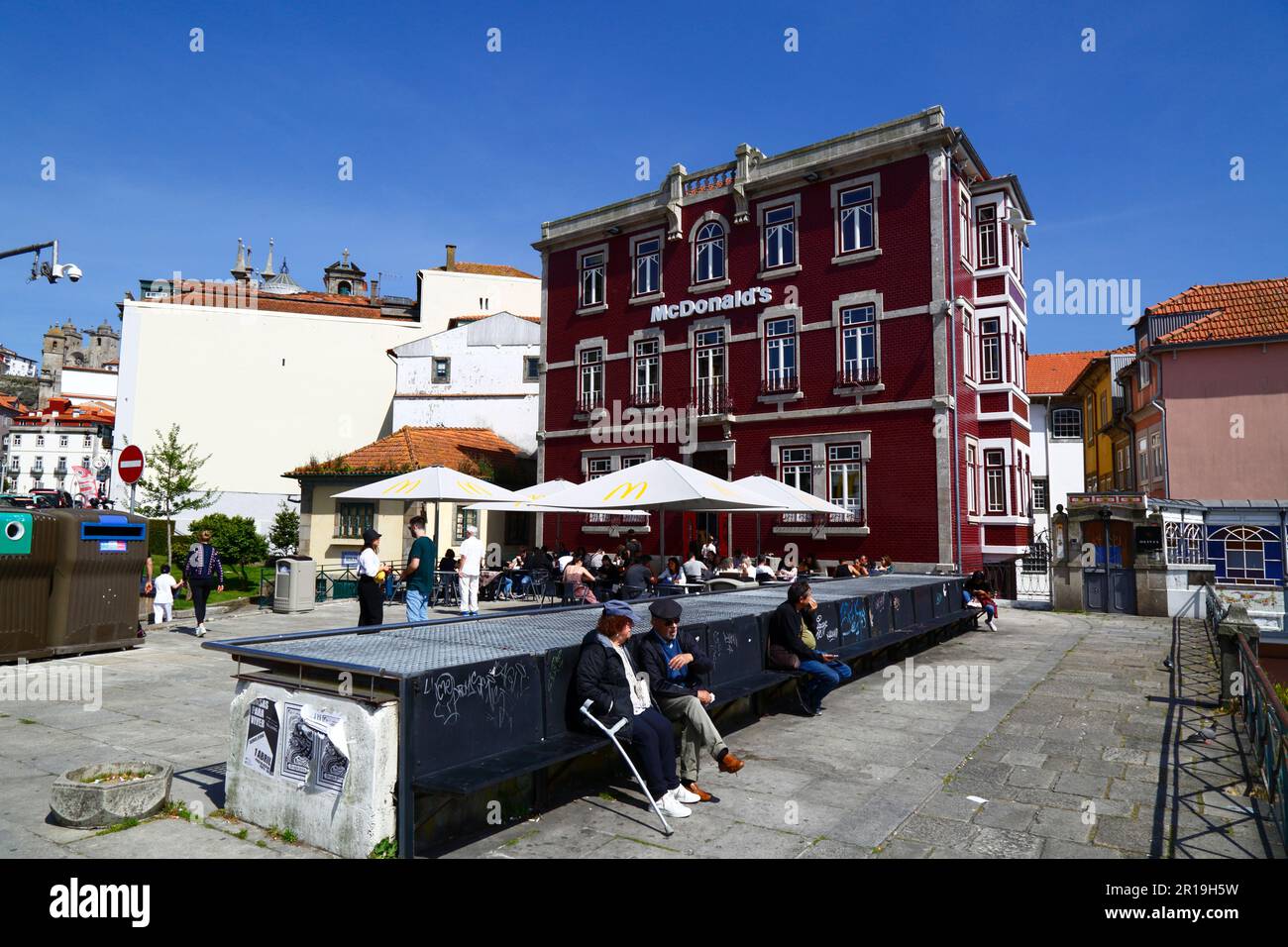 People sitting in square in front of McDonald's fast food outlet on Rua da Reboleira, Ribeira district, Porto / Oporto, Portugal Stock Photo