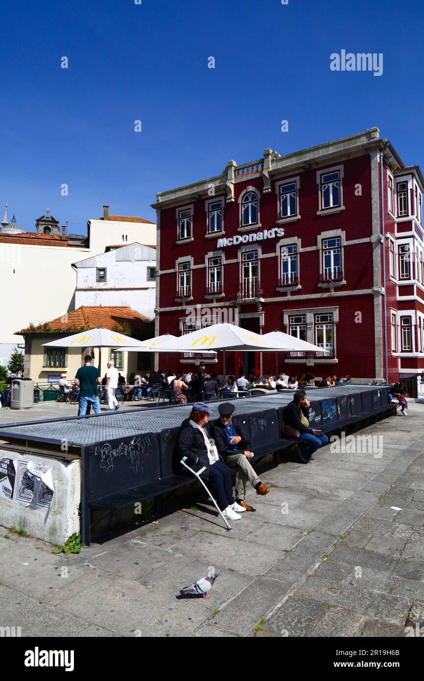 People sitting in square in front of McDonald's fast food outlet on Rua da Reboleira, Ribeira district, Porto / Oporto, Portugal Stock Photo