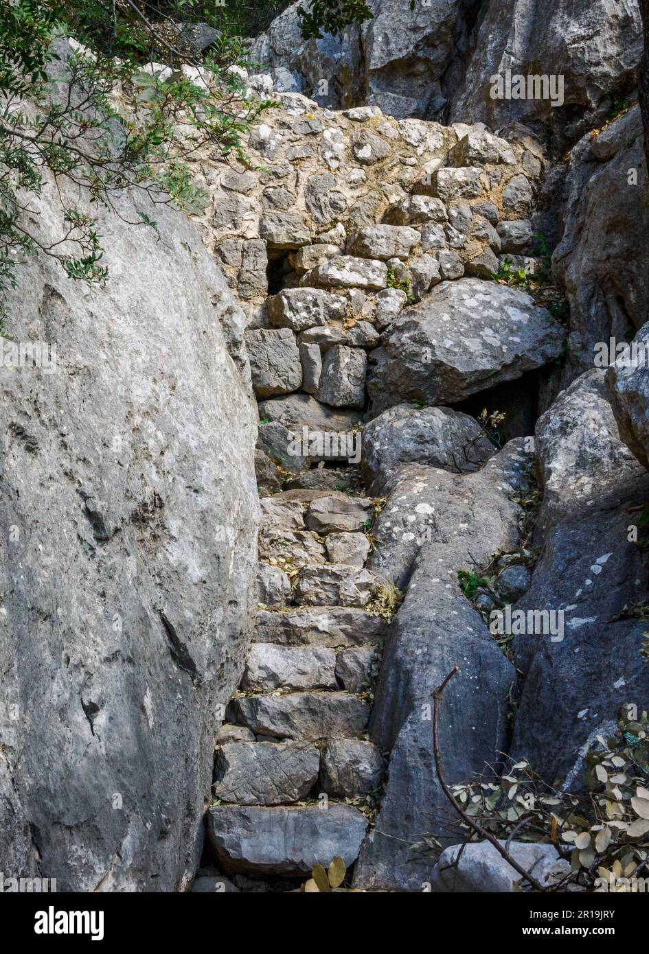 Stone steps climbing the narrow Pas de s'Escaleta between Alaro and Orient in the Tramuntana Mountains of Majorca Spain Stock Photo