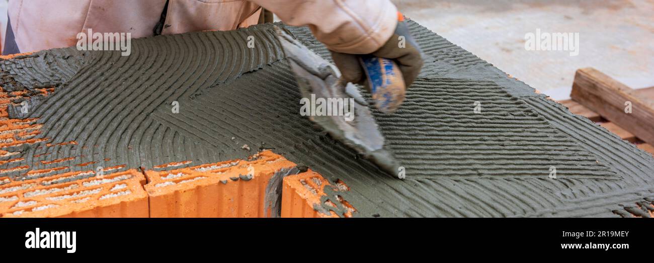 bricklayer working at new built home Stock Photo