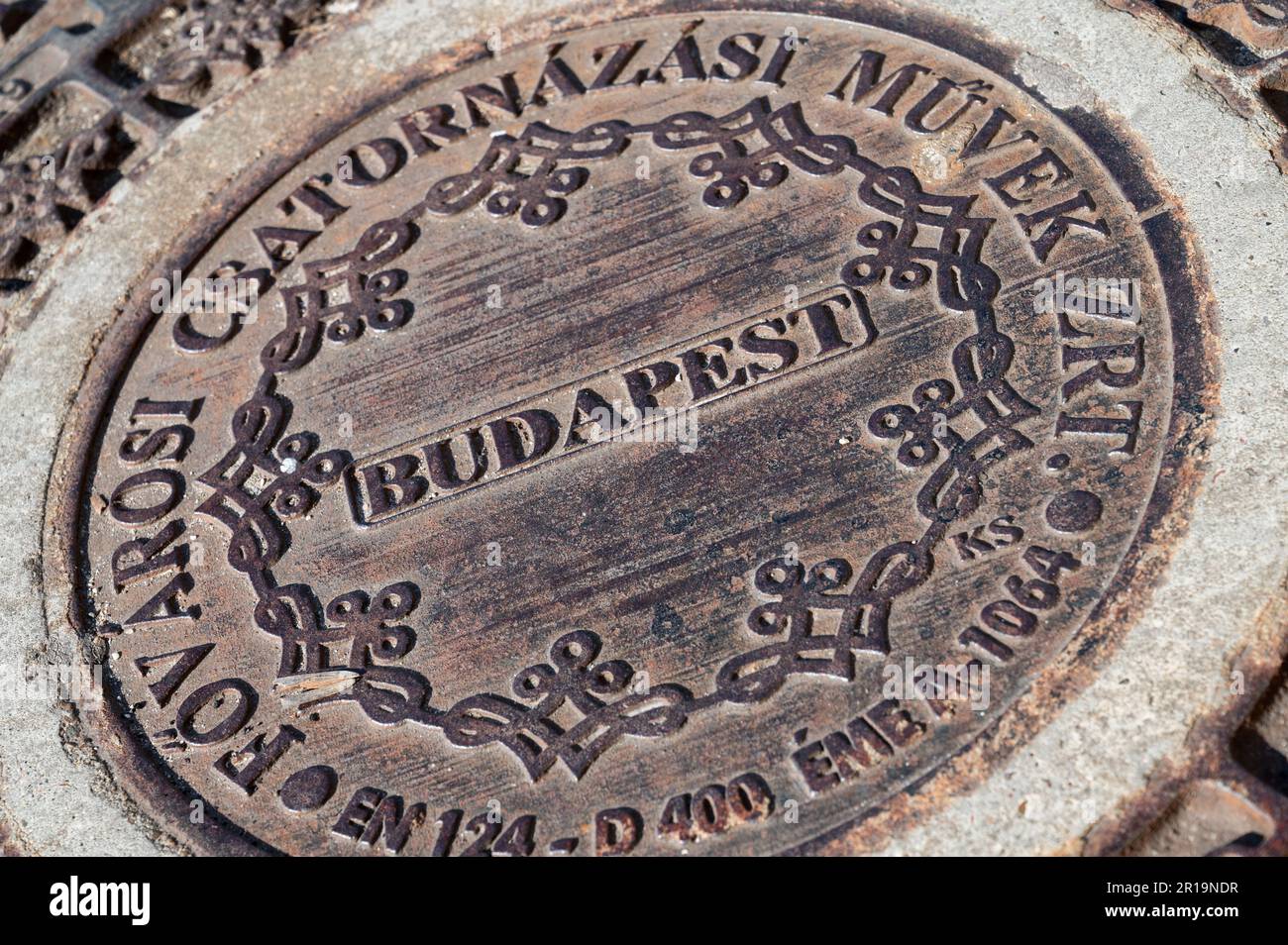 Stylised bronze manhole cover on the pedestrianised high street of Budapest, the capital city of Hungary Stock Photo