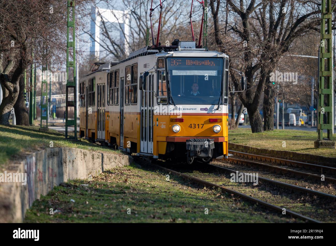 Distinctive yellow and white railway train and carriage providing transportation around the Hungarian capital city of Budapest Stock Photo