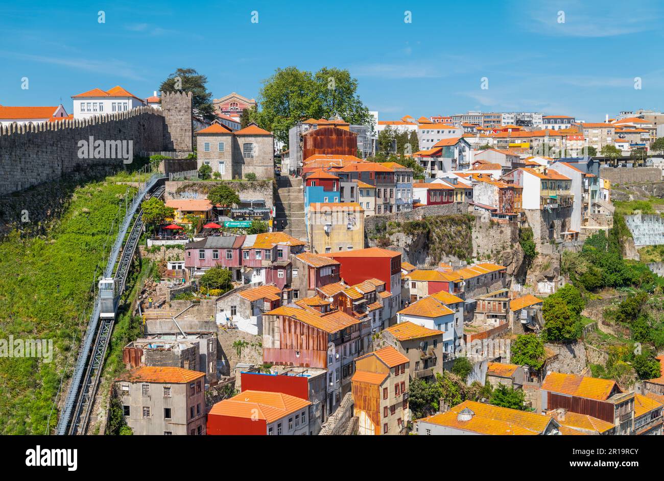 Porto, Portugal - April 18, 2023: The Ribeira district and the city walls seen from the Dom Louis I bridge Stock Photo