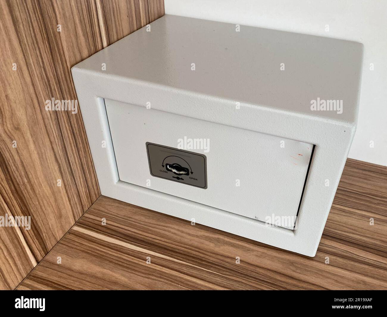 White iron small safe in the hotel room for storing valuables and money