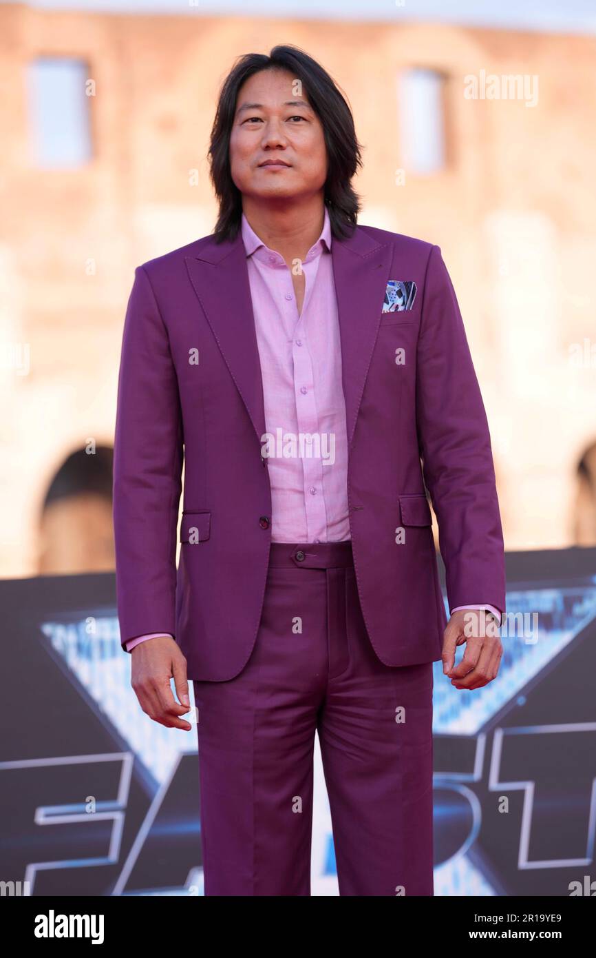 Actor Sung Kang poses for photographers upon arrival at the world