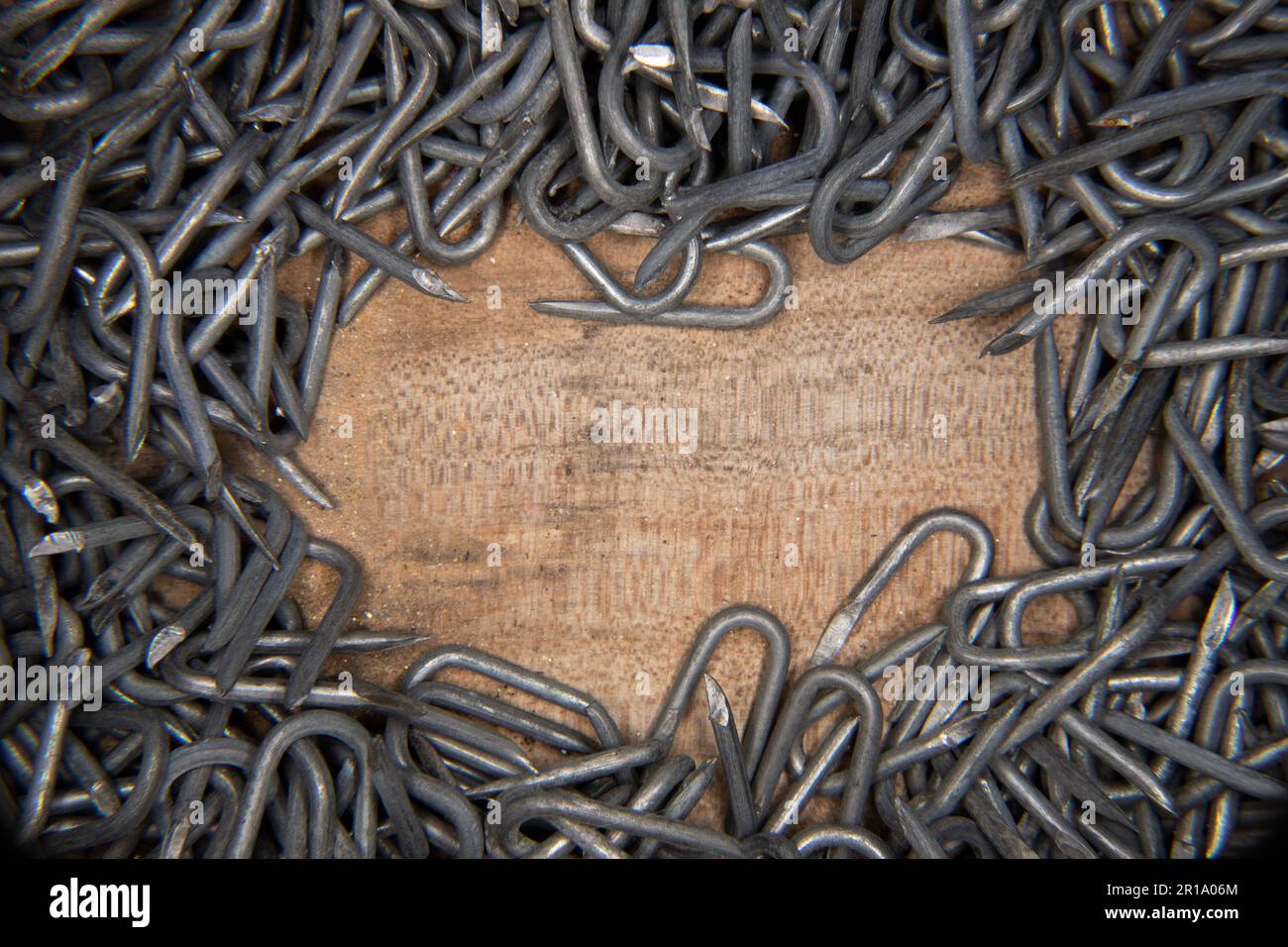 border made from pile of heavy barbed wire staples for construction and ...