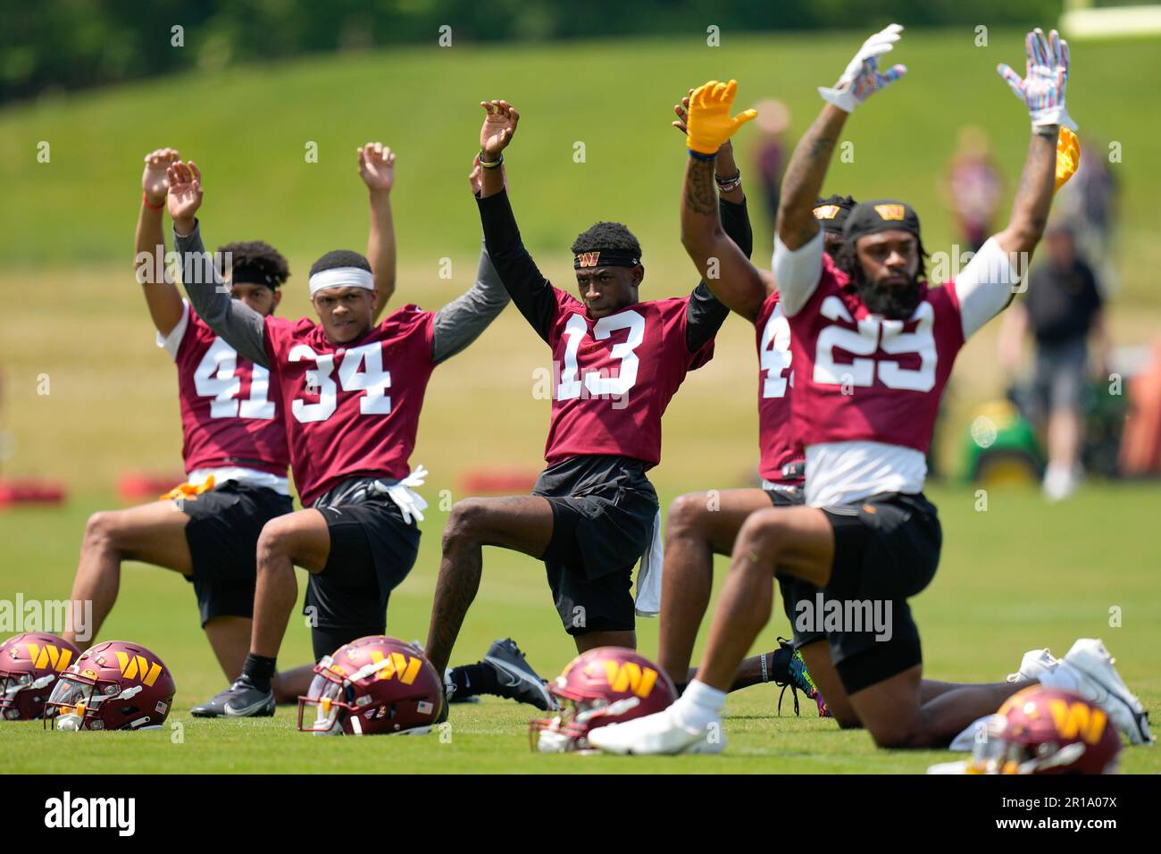 Washington Commanders cornerback Emmanuel Forbes Jr., (13) stretches
