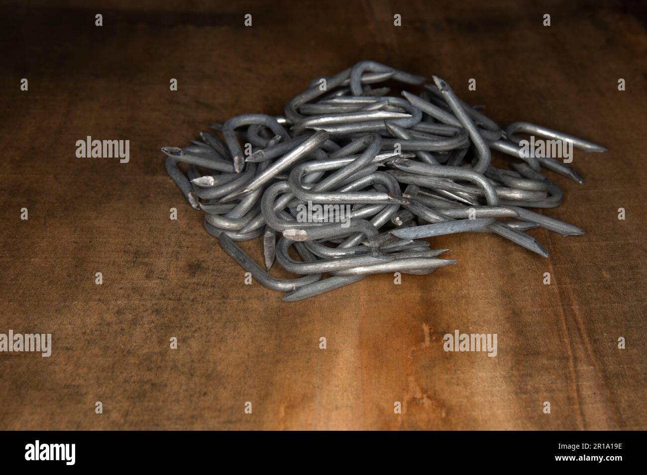 pile of heavy barbed wire staples for construction and carpentry Stock