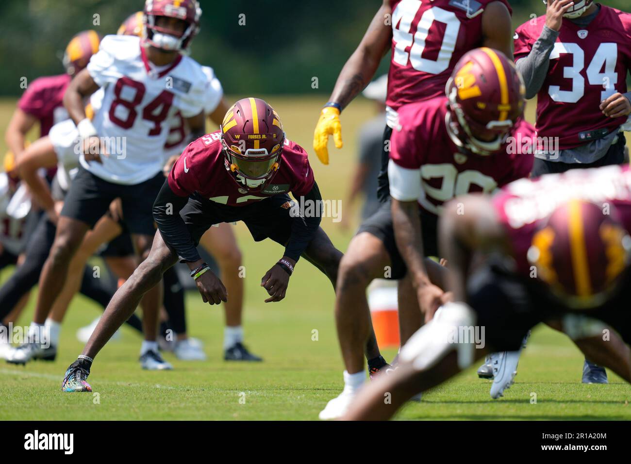 Washington Commanders cornerback Emmanuel Forbes Jr., (13) stretches