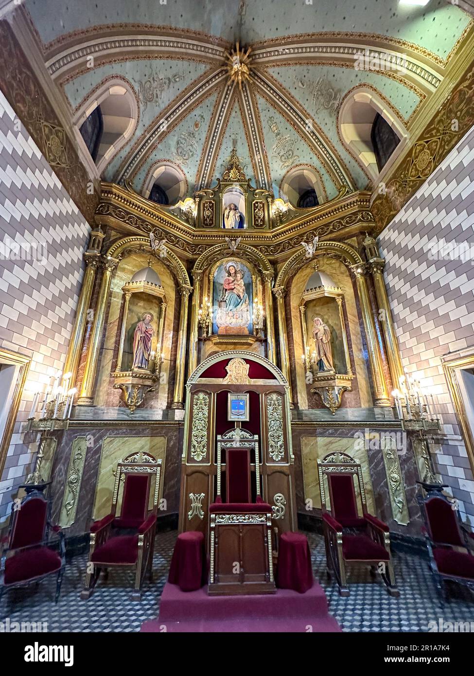 The cathedra or bishop's chair & main altarpiece in the apse of Our Lady of Loreto Cathedral, Mendoza, Argentina. Stock Photo