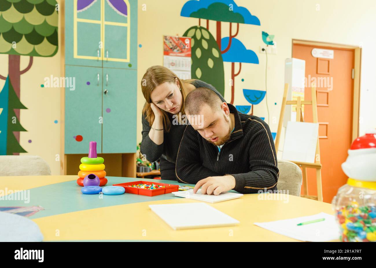 a psychologist is engaged with an adult autistic man in the office Stock Photo Alamy