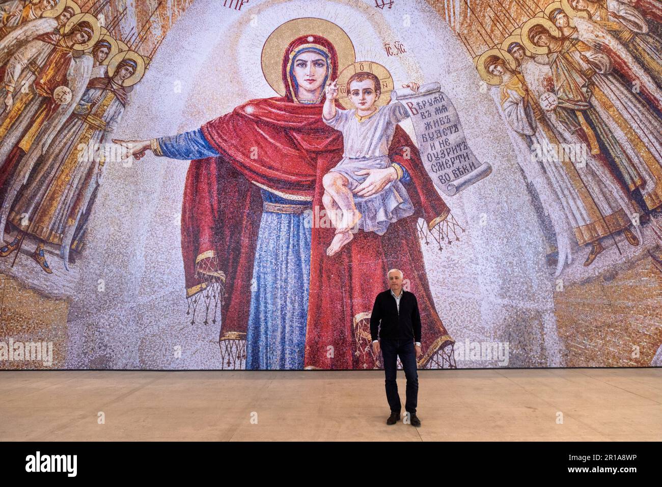 Moscow, Russia. 12th May, 2023. Artist Vasily Nesterenko at the exhibition of his works 'We are Russians, God is with us!' in the Central Exhibition Hall 'Manege' in Moscow, Russia. The exhibition presents reproductions of paintings by the artist of the Cathedral of Christ the Savior Stock Photo