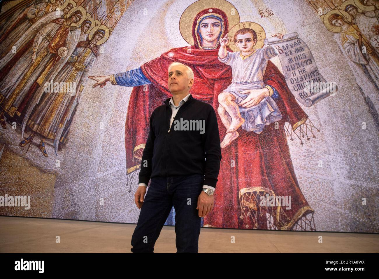Moscow, Russia. 12th May, 2023. Artist Vasily Nesterenko at the exhibition of his works 'We are Russians, God is with us!' in the Central Exhibition Hall 'Manege' in Moscow, Russia. The exhibition presents reproductions of paintings by the artist of the Cathedral of Christ the Savior Stock Photo