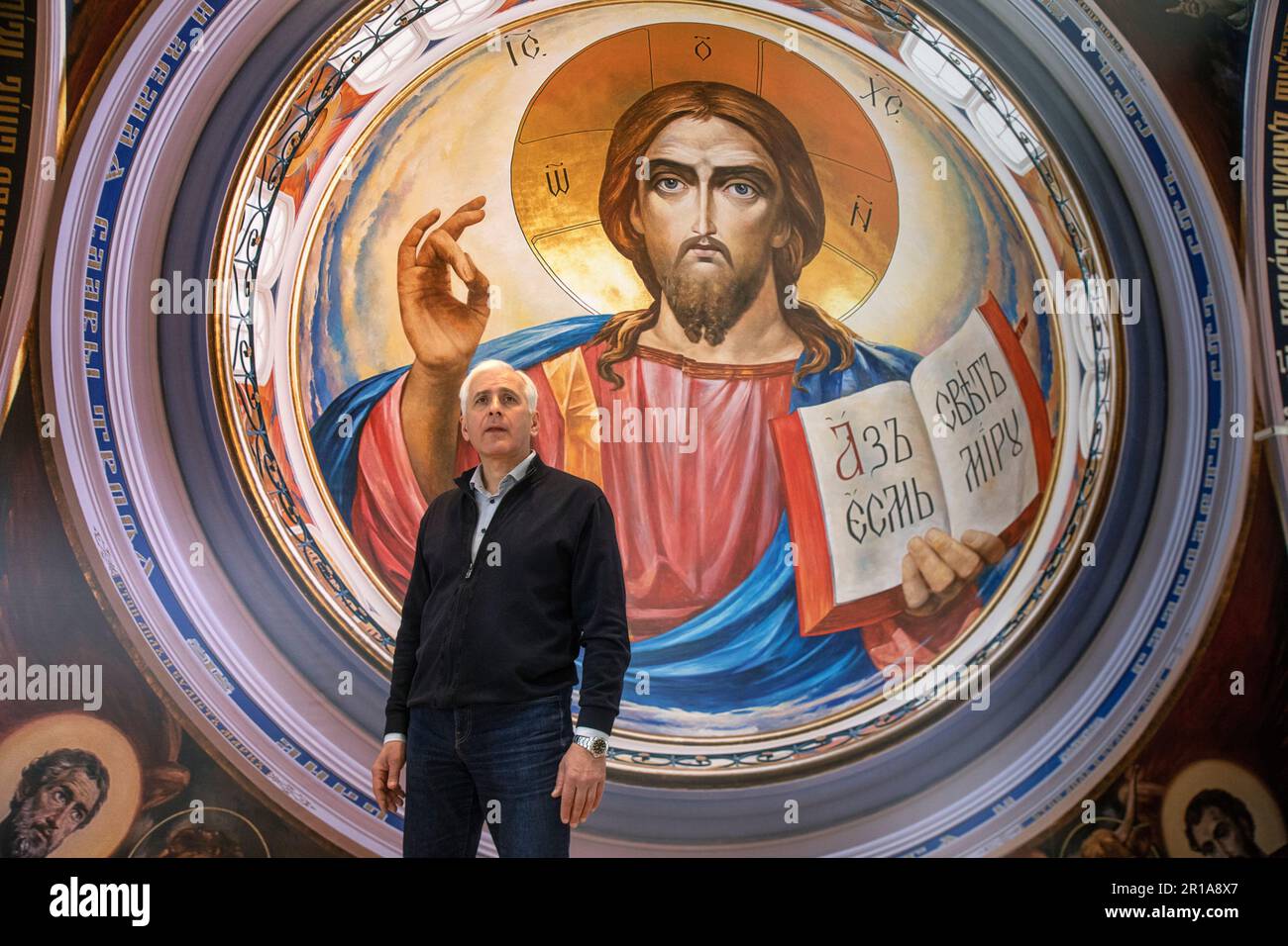 Moscow, Russia. 12th May, 2023. Artist Vasily Nesterenko at the exhibition of his works "We are Russians, God is with us!" in the Central Exhibition Hall "Manege" in Moscow, Russia. The exhibition presents reproductions of paintings by the artist of the Cathedral of Christ the Savior Stock Photo