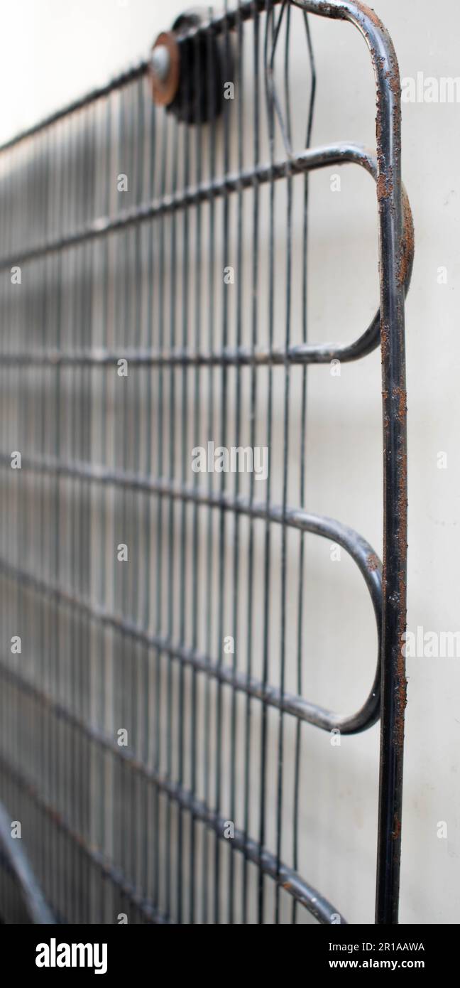 The rusty and dirty condenser coil of refrigerator or the backside of
