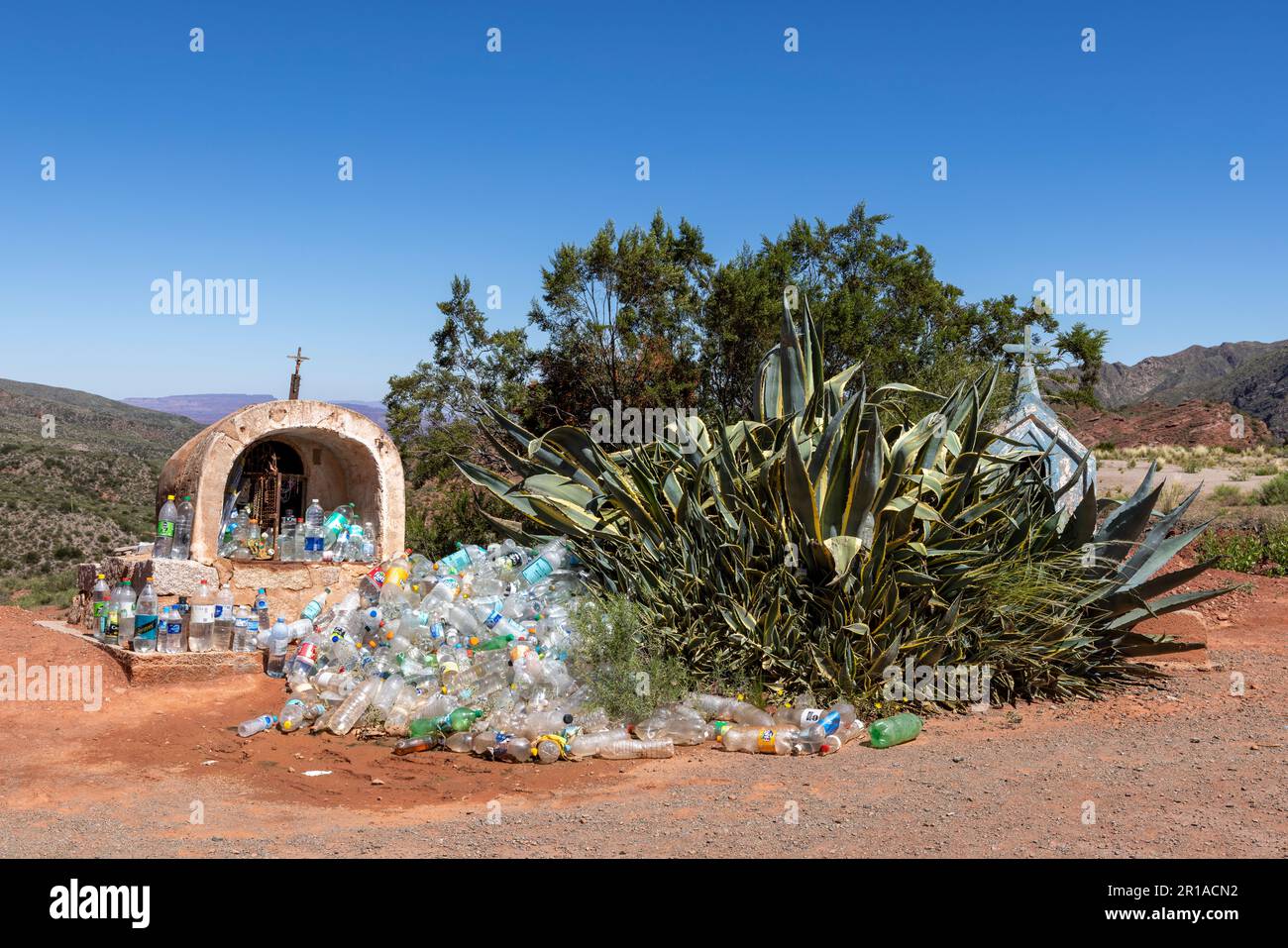 Sacrificial altar with bottles filled with water as an sacrificial offering to god(s) in the extremely dry region La Rioja in Argentina, South America Stock Photo