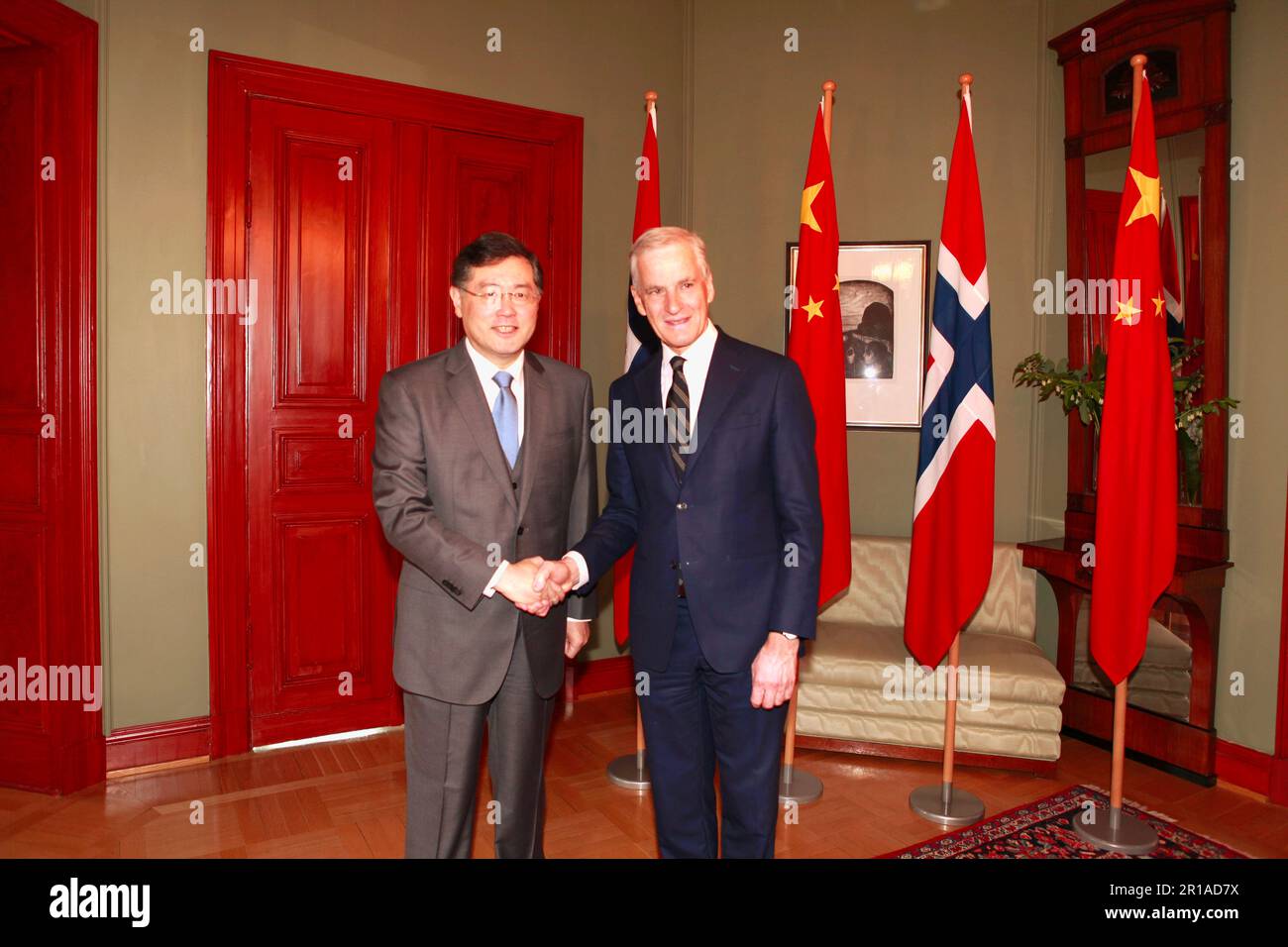 Oslo, Norway. 12th May, 2023. Norwegian Prime Minister Jonas Gahr Store (R) shakes hands with Chinese State Councilor and Foreign Minister Qin Gang during their meeting in Oslo, Norway, on May 12, 2023. Credit: Lin Jing/Xinhua/Alamy Live News Stock Photo