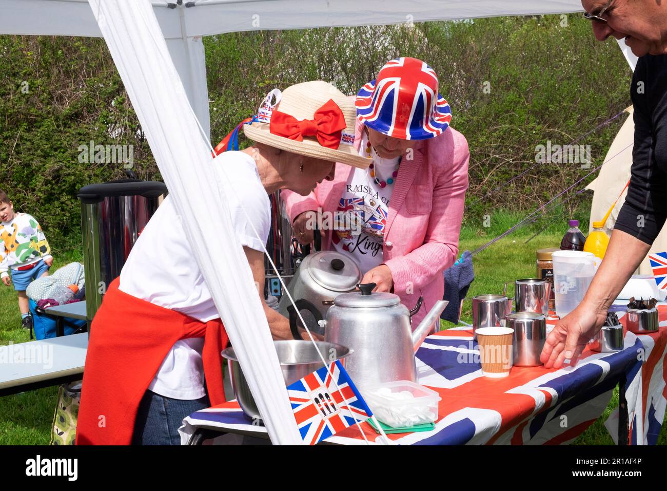 Women volunteers making tea helping out at Marloes village fete King Charles III coronation celebration Pembrokeshire Wales UK  May 2023 KATHY DEWITT Stock Photo