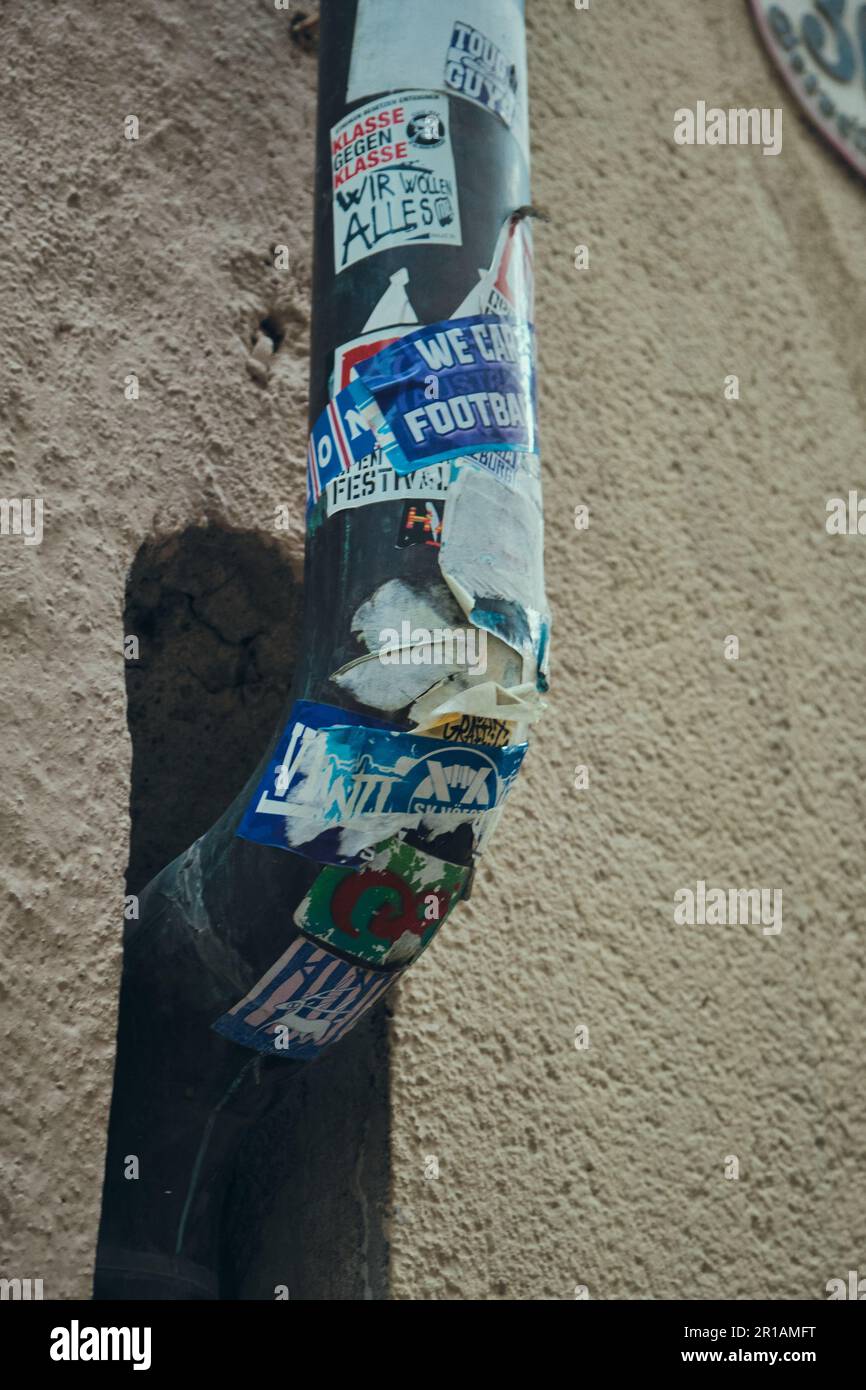 Sticker Pole In House A metal pole with a variety of colorful stickers attached to it next to ...