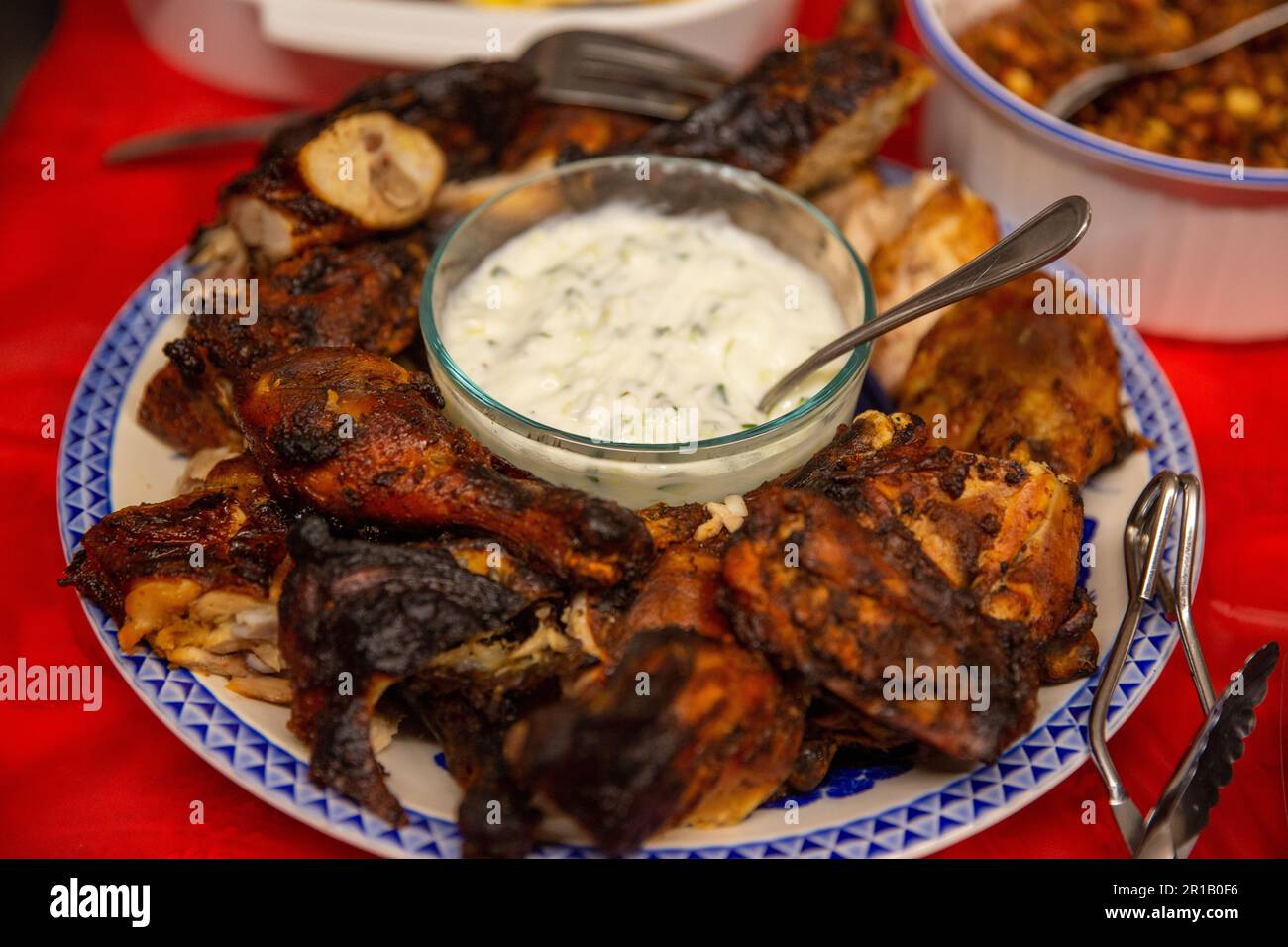 Indian Tandoori Chicken with Yogurt sauce plated Stock Photo Alamy