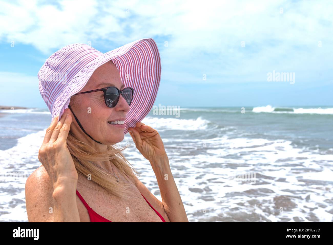 Mature woman enjoying herself on the beach Stock Photo - Alamy