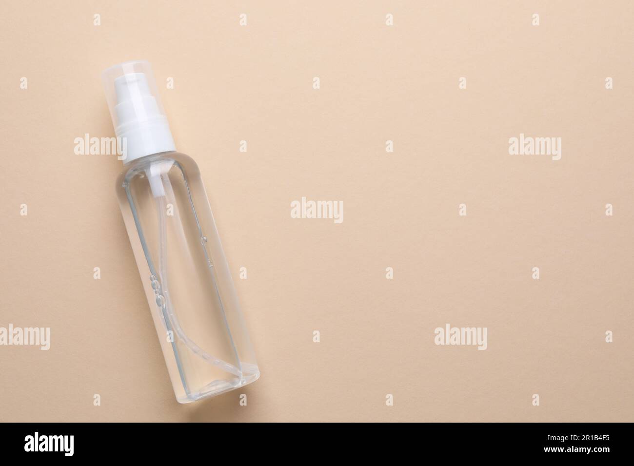 Micellar water on beige background, top view. Space for text Stock Photo