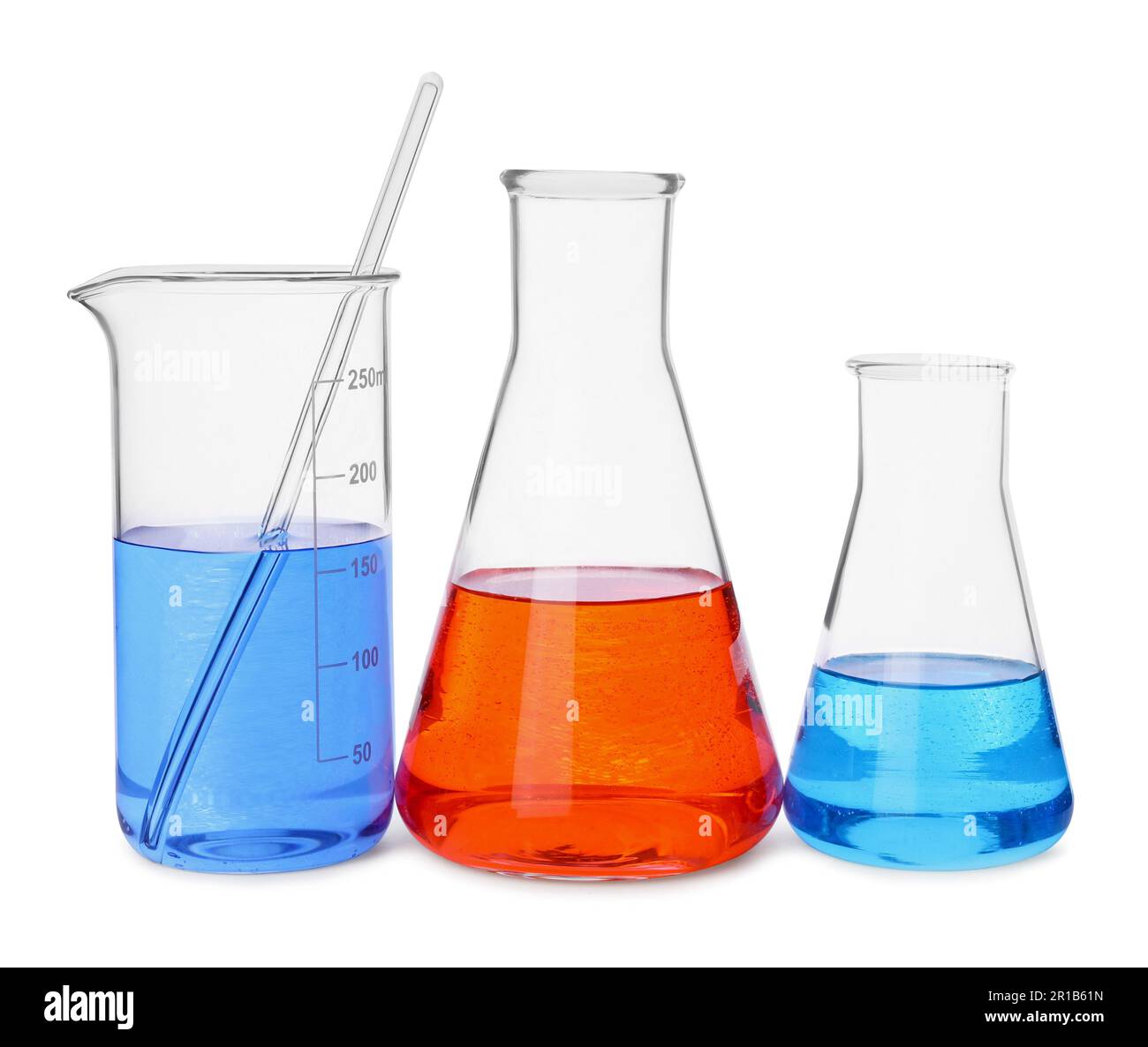 Different laboratory glassware with colorful liquids on white
