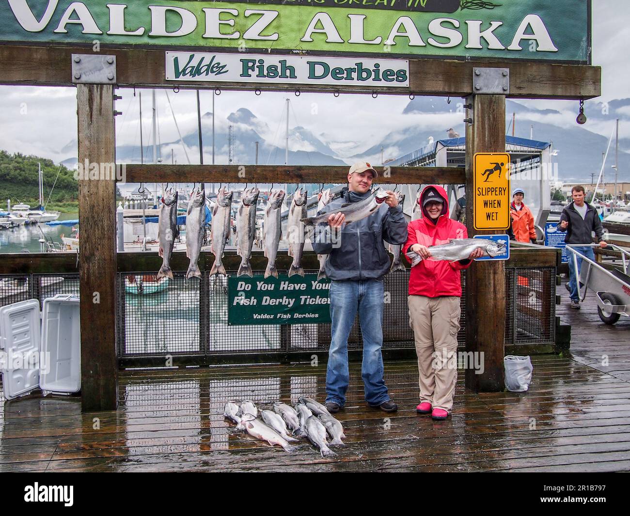 Two happy people showing off the Silver Salmon (Oncorhynchus kisutch