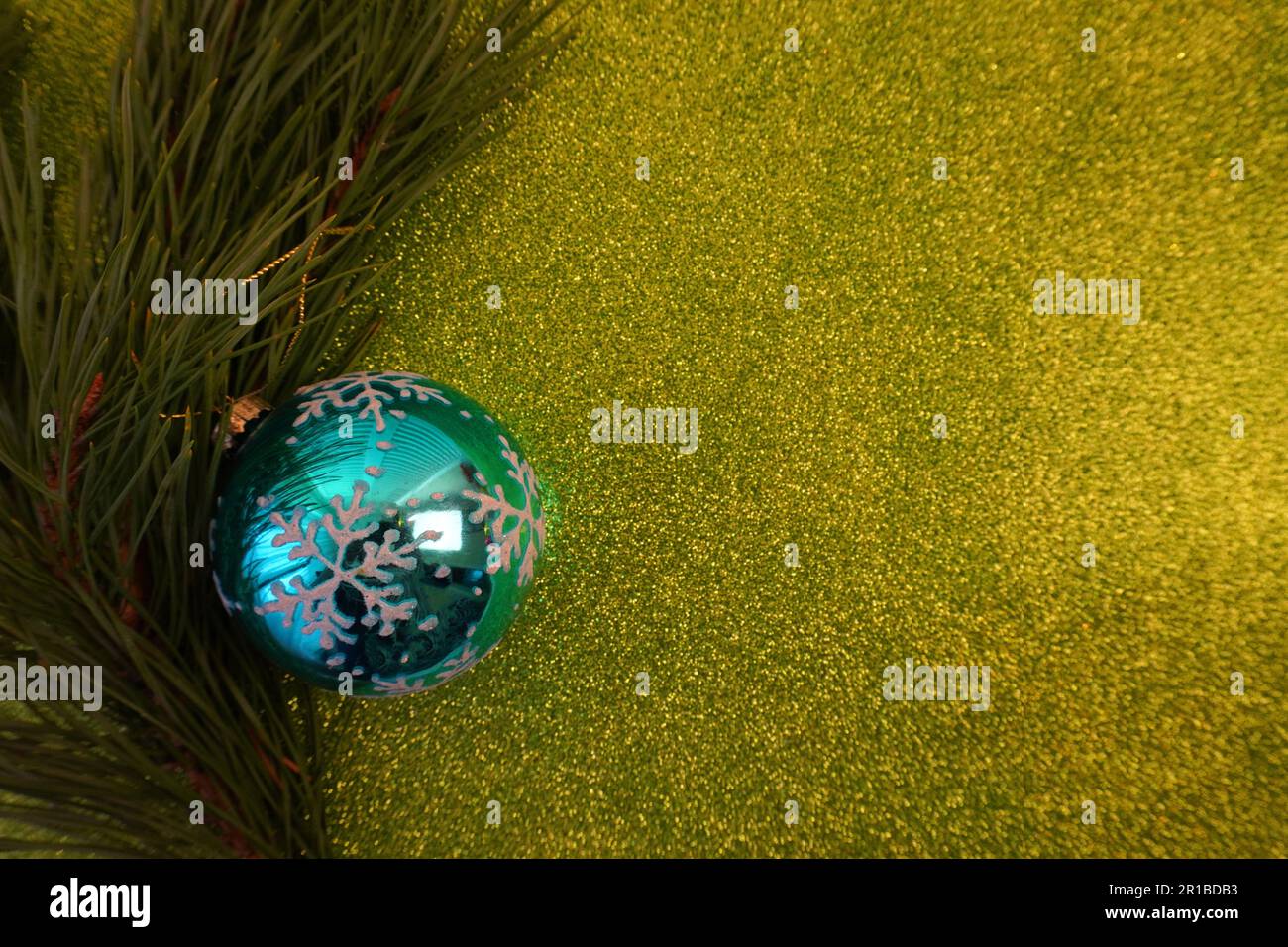 green christmas background with fir tree branch and christmas balls and ...