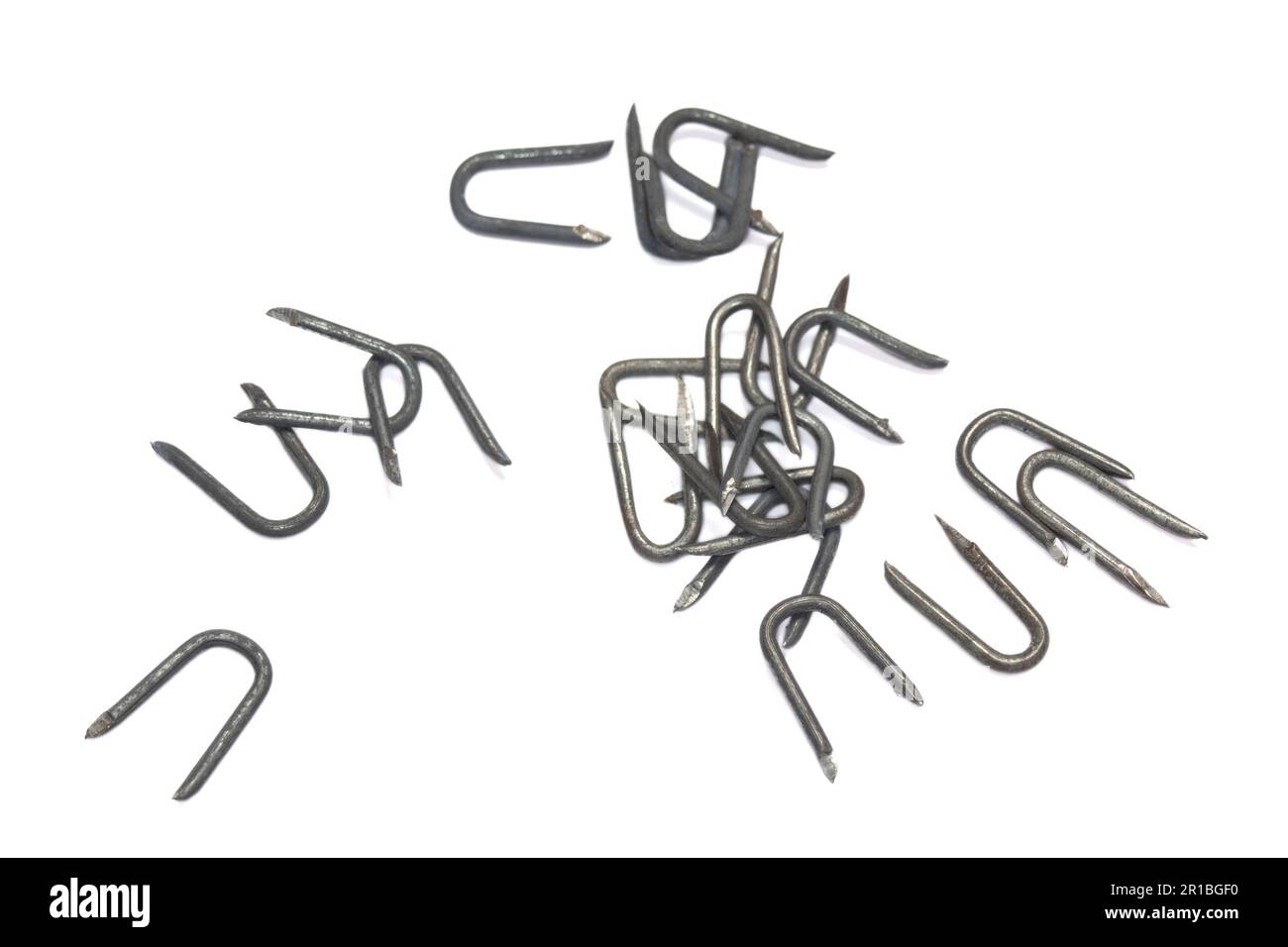 pile of heavy barbed wire staples for construction and carpentry Stock